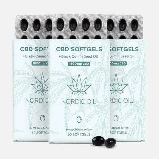 Três embalagens de Nordic Oil CBD Softgels com óleo de sementes de cominho preto, cápsulas pretas à frente.